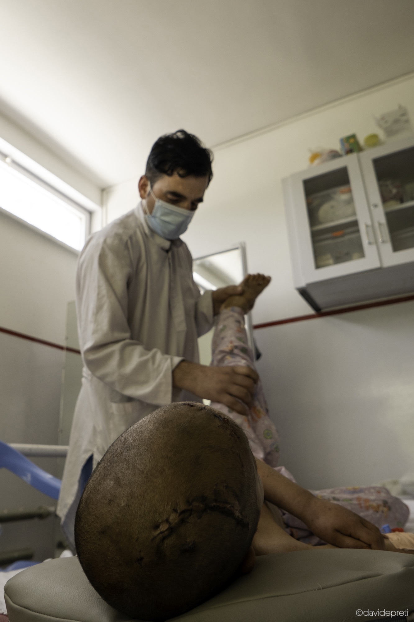 Kabul, Afghanistan — July 6, 2021.

RASHAD - 9 yo

Maidan Shahr is a town about 50 km from Kabul, along the main road connecting the capital to Kandahar. It is where Rashad, 9, comes from. A few weeks ago, he was playing in his courtyard when shrapnel from a mortar explosion struck him in the head. After being stabilized at the First Aid Post in the city, he was transferred to the EMERGENCY hospital in Kabul, where he underwent emergency surgery.

A week later, he began his rehabilitation with Hashim, one of the hospital's physiotherapists.
