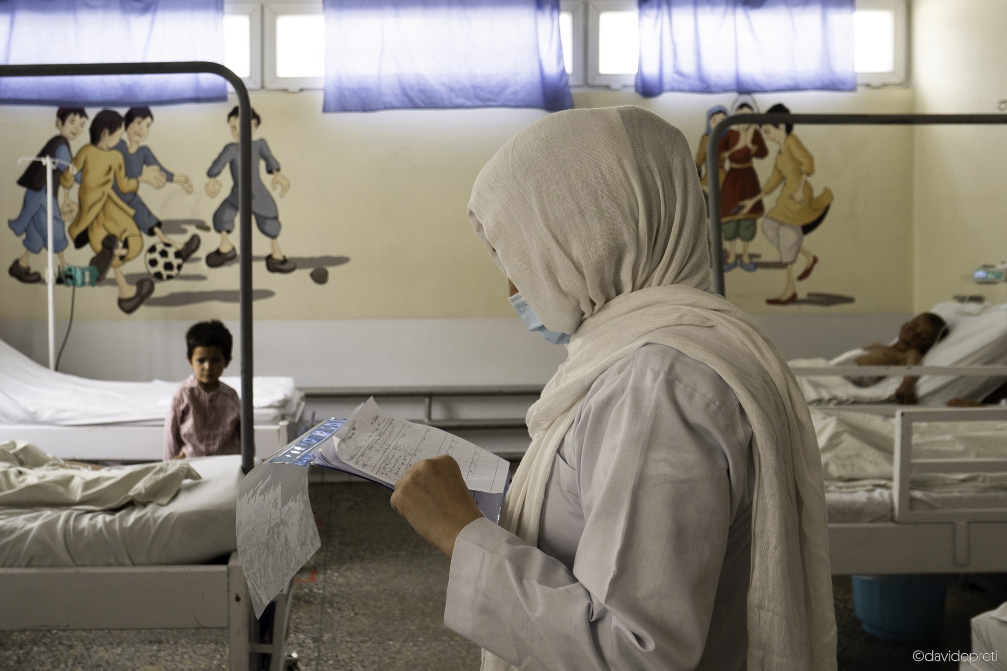 Kabul, Afghanistan — July 14, 2021.

Nurse Laila checks the patient files inside the C-ward (Children ward) EMERGENCY's Surgical Centre for War Victims in Kabul.
