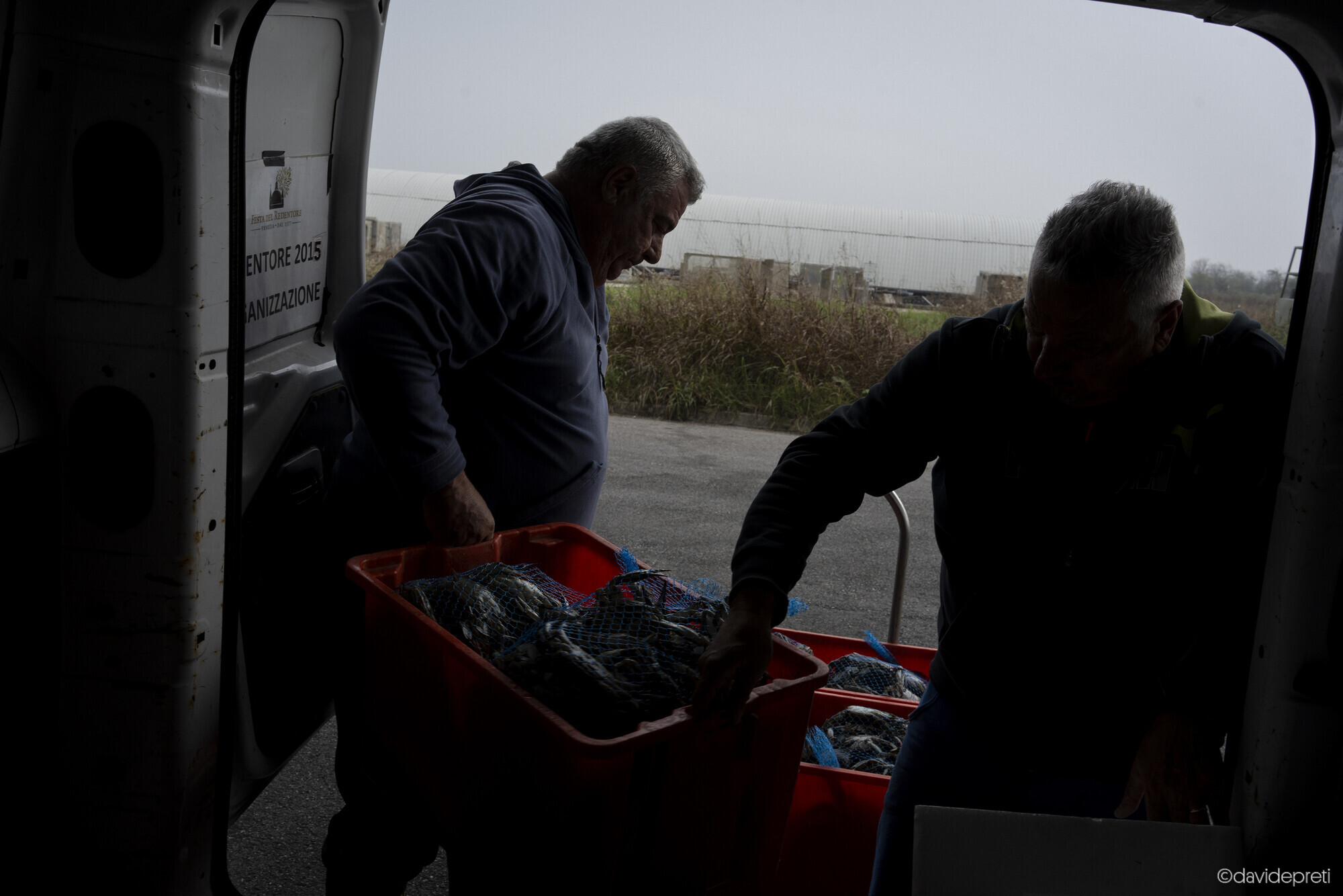 Scardovari Lagoon, Italy — November 8, 2024.

Massimo and Moreno unloading bags of blue crabs outside the Scardovari fishermen's cooperative.
