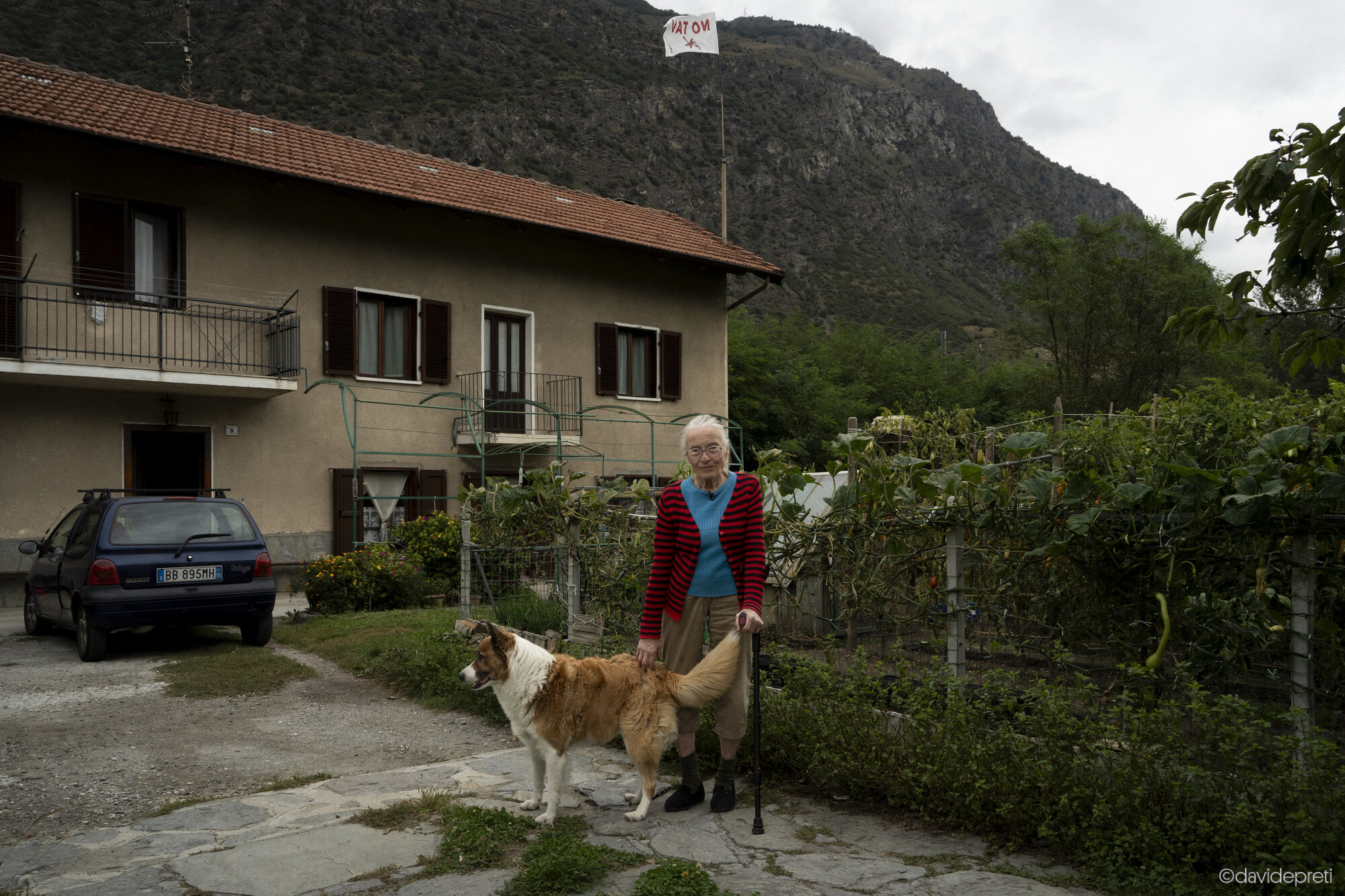 Bussoleno, Italy — September 18, 2024.

INES - 86 yo

Standing outside the home she has lived in for over 50 years, shortly before its scheduled demolition for the construction of the Lyon-Turin high-speed rail line (TAV) in the Susa Valley.
