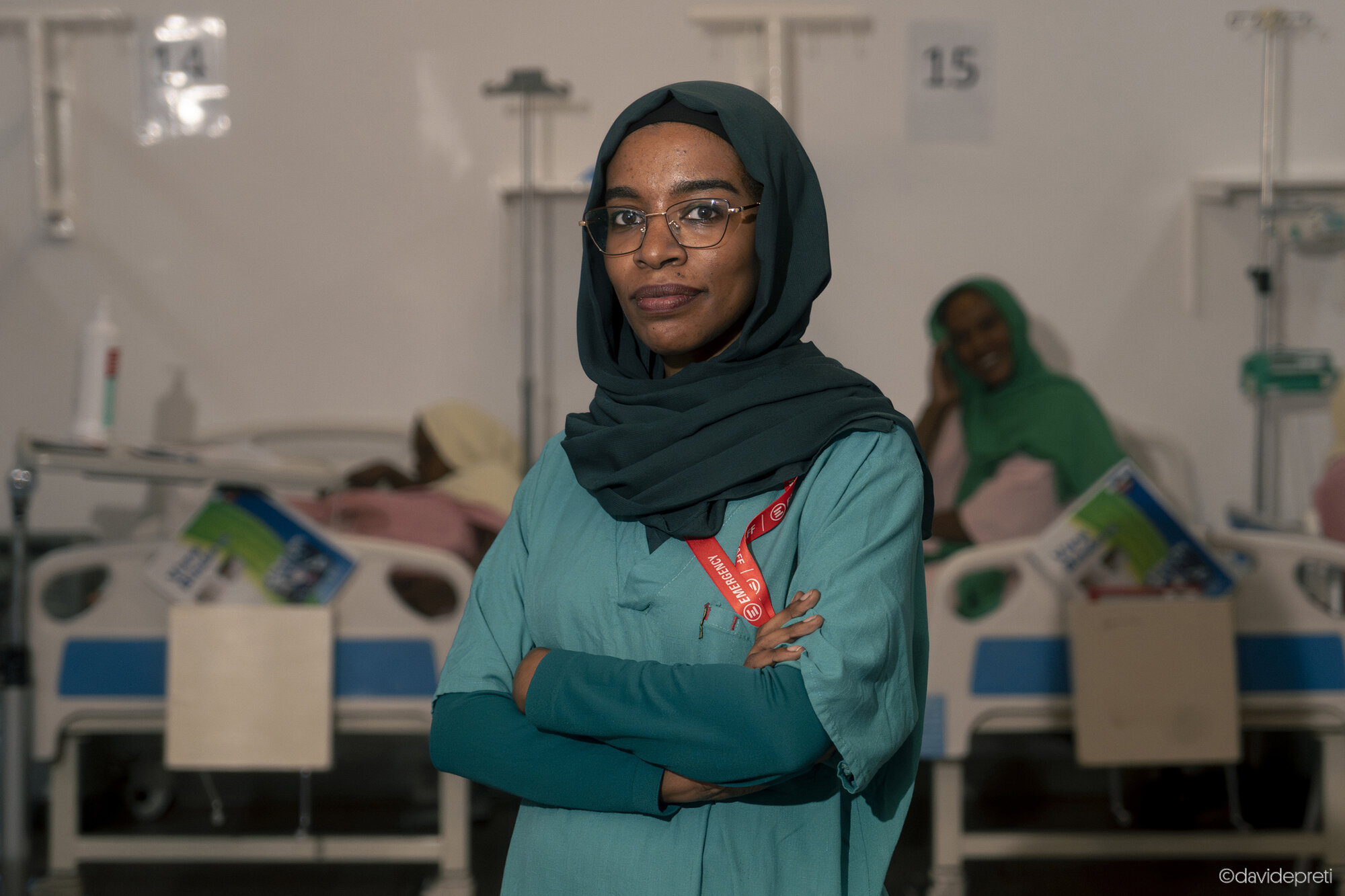 Khartoum, Sudan — November 18, 2025.

FADWA - 33 yo

She is a pediatrician. She grew up among her father's medical books and remembers a professor's advice: "Pediatrics is not just about the child; you must treat the entire family."

On April 15, 2023, the war upended her life. "Soldiers passed by, firing weapons; a bullet shattered our window." With a father and two brothers who are doctors at risk of forced recruitment by the RSF, the whole family fled to El Goled, her father's village near Dongola. The journey took sixteen hours and passed through 66 checkpoints. Her brothers found a job abroad; Fadwa stayed. She worked in El Goled for two years before returning to Khartoum to join EMERGENCY's Salam Centre.

"Omdurman showed some signs of life," she says, "but central Khartoum was ghostly." The greatest shock came near the cemetery: "There were so many dead that they began burying them outside the fence. That was when I started to cry."

"Today, treating children is the only way I can help my country," she says. She struggles with the guilt of having been away from her city for two years.
