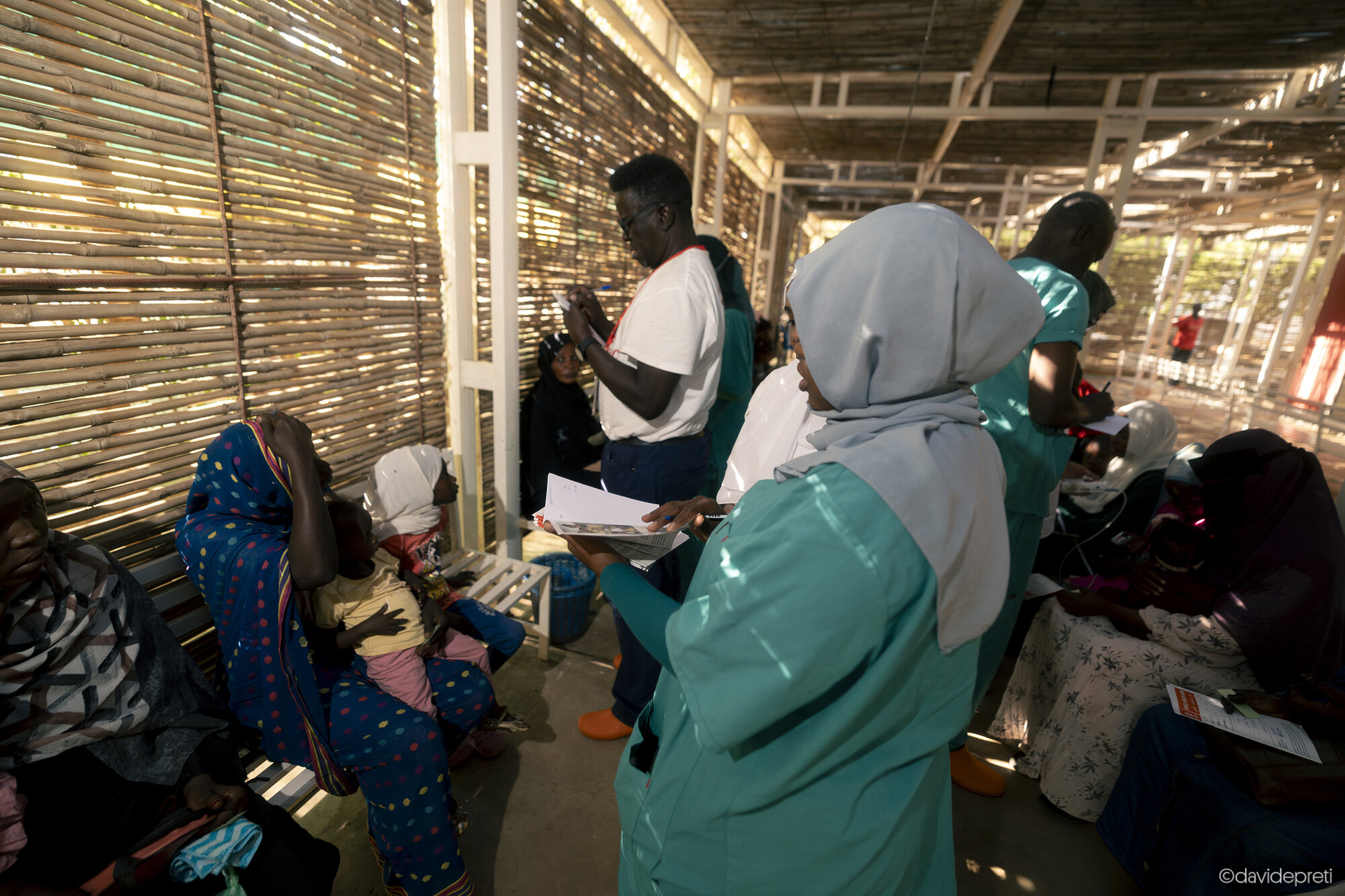 Khartoum, Sudan — November 20, 2025.

Nurses and healthcare workers conduct medical triage in the outdoor waiting area of the pediatric ward at EMERGENCY's Salam Centre.
