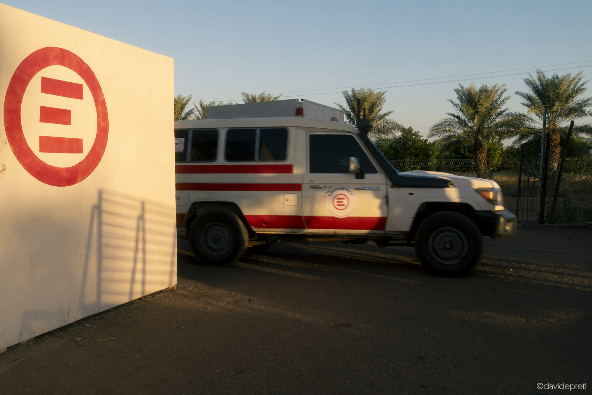 Khartoum, Sudan — November 20, 2025.

An ambulance passes through the main gate of EMERGENCY's Salam Centre for Cardiac Surgery to navigate the streets of the capital.
