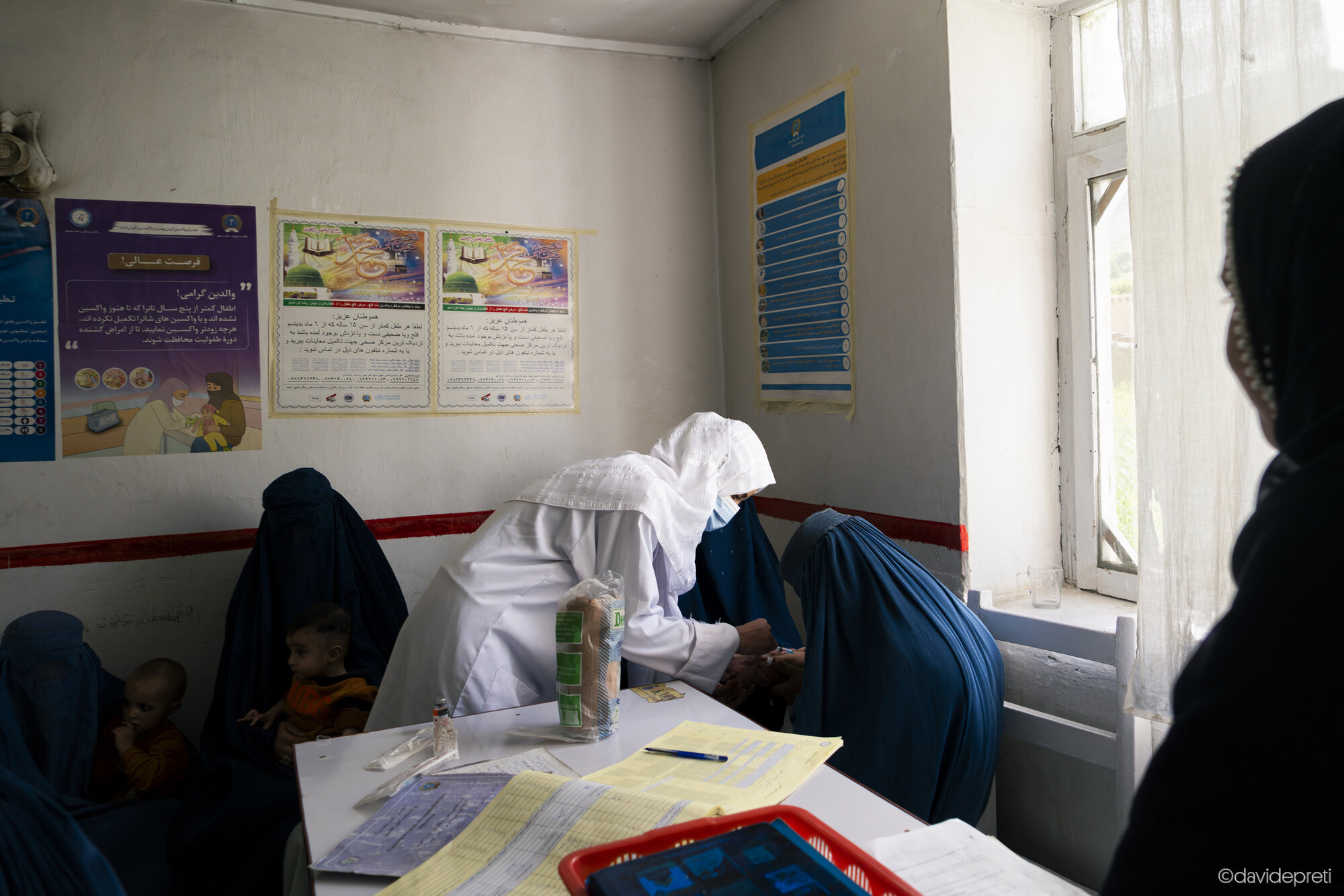 Anjuman, Afghanistan — July 10, 2025.

ZEYNAB (PSEUDONYM)

Healthcare worker administering vaccinations and conducting triage for local village women inside the EMERGENCY First Aid Post (FAP) in Anjuman.
