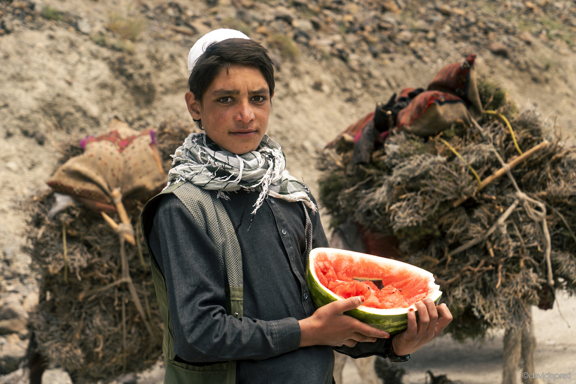 Badakhshan Valley, Afghanistan — July 10, 2025.

A local resident eating a slice of watermelon to cool off while returning home with his mules after a day's work in the Badakhshan Valley, gateway to the Pamir region.
