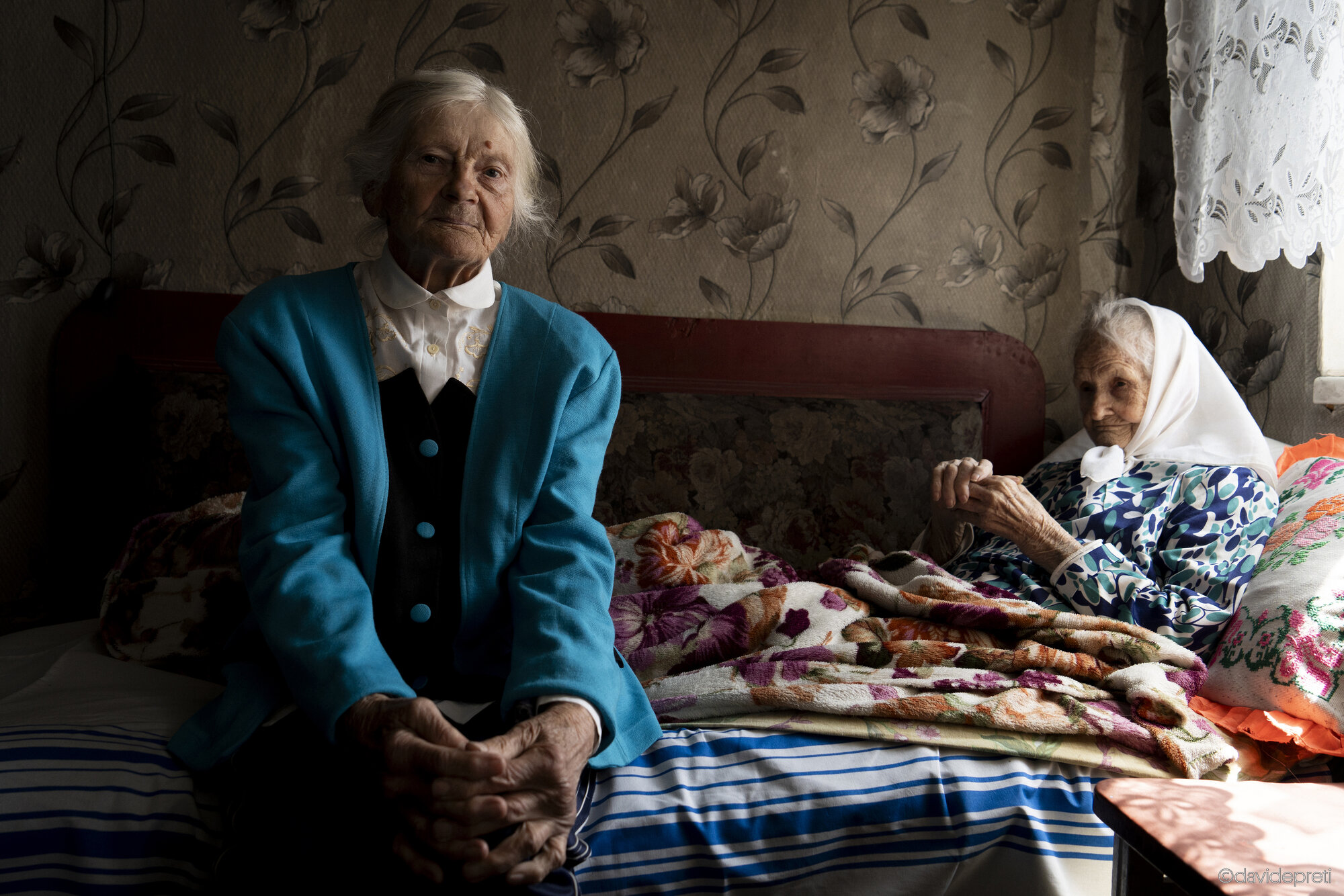 Dmytrokolyne, Ukraine — April 18, 2025.

OLGA - 100 yo, ANNA - 95 yo

I was born in 1925; there were five of us. In 1932, I lived through the Holodomor. I was only five years old, but I remember it well. By fifteen, it felt like things were getting better, but then in 1941, war broke out. I was sixteen. They took us to dig trenches, even though we were skeletal from hunger.

In 1942, a German took me to Germany by force. I remained there for four years. I returned at the end of '45 and found only my bedridden, paralyzed mother, my 14-year-old brother, and my 11-year-old sister. My father was gone. So I went to work at the kolkhoz. My mother died in '46. I was 21 years old, with two children to care for. In 1947, hunger returned. I worked all day, and in the evening my brother and sister would run to me crying: "We're hungry…" All we had to share were beets.

In 1948, I volunteered to go to Dnipro to rebuild the city destroyed by the war. The foreman didn't want to let me go, but in the end, the kolkhoz chairman gave me permission. We worked hard there: we laid 16 meters of railway track a day. Then we built a hospital, and finally, we helped divers from Moscow lay pipes in the Dnipro River. While working one day, a log fell on my left foot: shattered bones, torn skin. They performed emergency surgery and managed to save my foot. I stayed in the hospital for a month and a half.

When I recovered, I went to Kramatorsk because there was too much poverty in my village. I worked for four years at NKMZ (a large heavy engineering plant) as a painter. Then I got married and had a daughter, so I stayed home for two years. Afterwards, I returned to work at a large cement and slate factory. It produced the gray bricks you still see in buildings today. I worked there until 1977, and later found a job at the Kuibyshev factory, where I stayed until retirement.

Today I live here, in my village, about an hour and a half from Kramatorsk. This is where I was born, and where I always returned to help. I painted, repaired walls, and worked in the garden. Then my husband fell ill. He died in 1989, at only 57 years old. I was left alone with my daughter. She got married, and my grandson was born. But her husband drank too much and lost several jobs. In the end, he took his own life. So I stayed with them, always trying to help them however I could.

